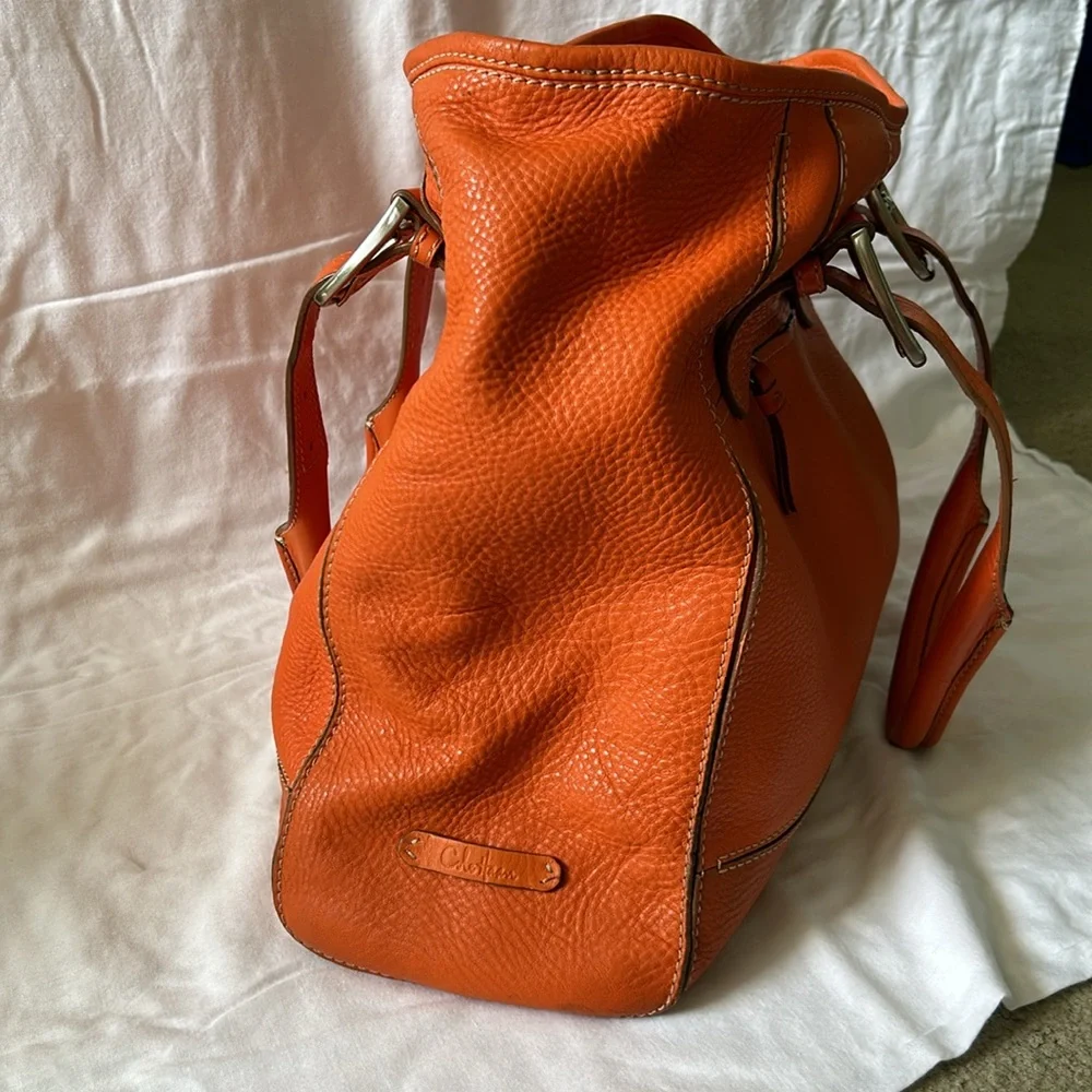 Large leather Cole Haan orange shoulder bag with silver hardware buckles. - Picture 4 of 16